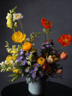 Bouquet of colorful flowers in a white vase against a dark background, Austin TX delivery today