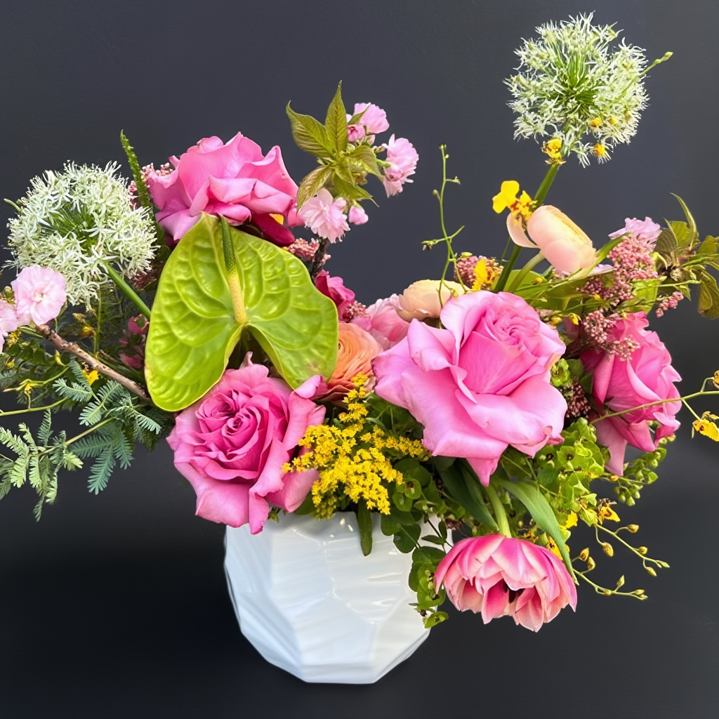 Austin Texas Delivery Bouquet of pink roses and other flowers in a white vase on a dark background
