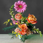 Bouquet of colorful flowers in a vase against a teal background hand designed 
