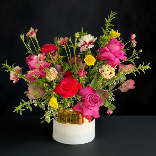 Luxury arrangement by Posey Floral for delivery in Austin Texas contains bright pink roses hellebores and daffodils for online floral delivery in Austin