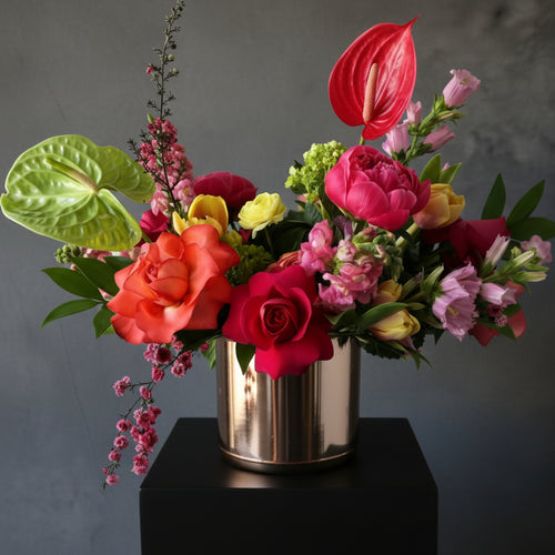 affordable Colorful flower arrangement in a metallic vase hand designed in Austin TX with delivery anthurium